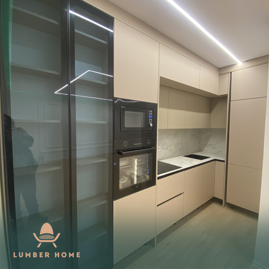 Cream kitchen with a glass display cabinet and integrated appliances